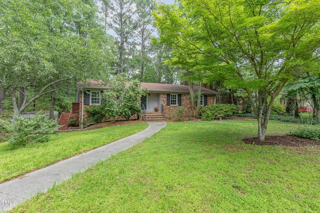 4030 King Charles Rd, Durham, NC 27707 - ranch-style home with a front lawn, a chimney, and brick siding