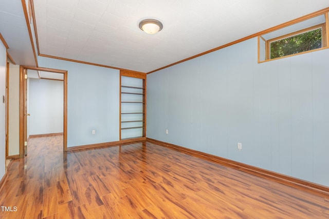 4030 King Charles Rd, Durham, NC 27707 - spare room with ornamental molding, wood finished floors, baseboards, and built in shelves