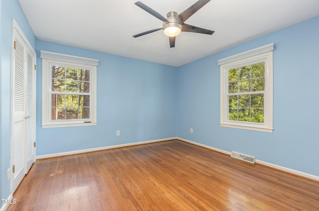 4030 King Charles Rd, Durham, NC 27707 - unfurnished bedroom with wood finished floors, baseboards, a closet, and a ceiling fan