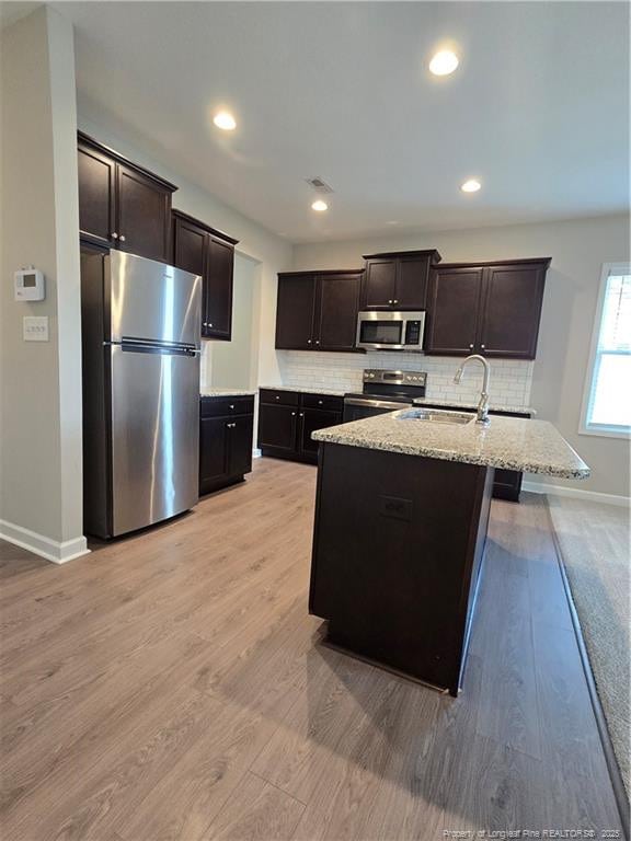 338 E David Parnell St, Parkton, NC 28371 - kitchen with stainless steel appliances, baseboards, tasteful backsplash, light wood-style flooring, and recessed lighting