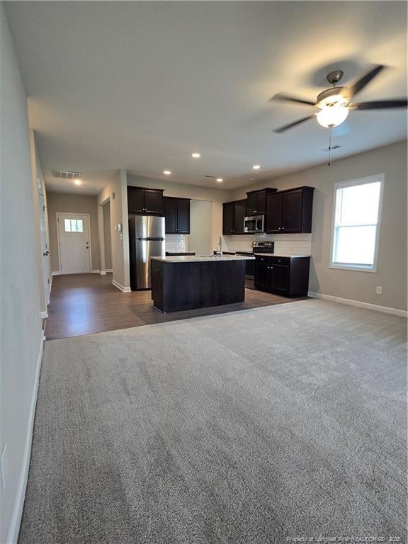 338 E David Parnell St, Parkton, NC 28371 - kitchen featuring stainless steel appliances, baseboards, carpet flooring, open floor plan, and recessed lighting