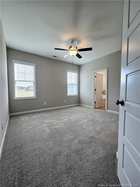 338 E David Parnell St, Parkton, NC 28371 - unfurnished room featuring baseboards, carpet, and ceiling fan