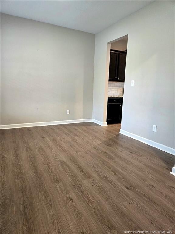 338 E David Parnell St, Parkton, NC 28371 - empty room with dark wood finished floors and baseboards