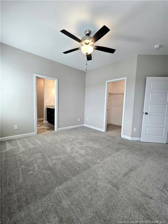 338 E David Parnell St, Parkton, NC 28371 - unfurnished bedroom featuring a spacious closet, carpet flooring, a closet, and ceiling fan