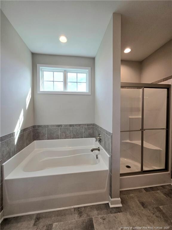 338 E David Parnell St, Parkton, NC 28371 - full bathroom with a garden tub, a shower stall, and recessed lighting