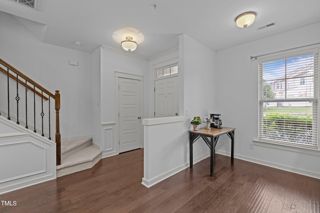 foyer with dark wood-style flooring, stairway, and baseboards