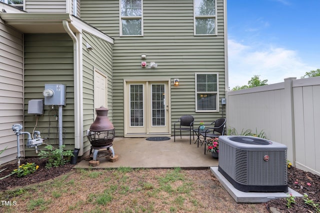 rear view of house with central AC, fence, and a patio
