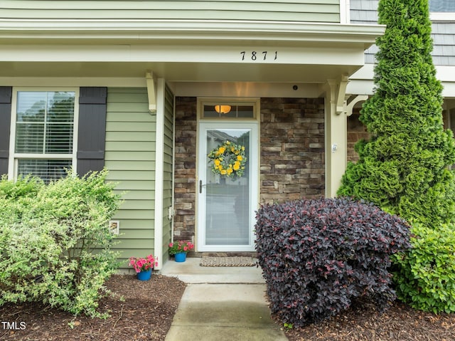 entrance to property with stone siding