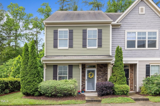 multi unit property featuring roof with shingles
