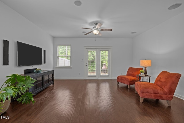 living area with ceiling fan, wood finished floors, and baseboards