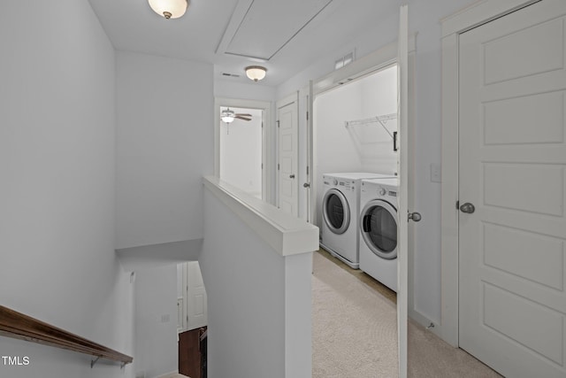 laundry area with washer and dryer and light carpet