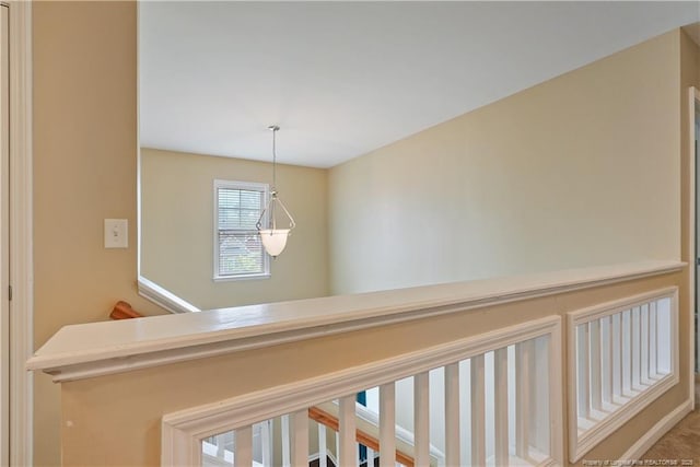 hallway featuring an upstairs landing