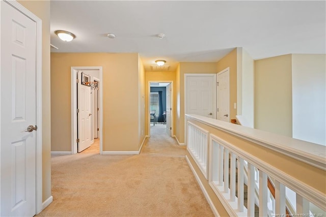 hall with light carpet and baseboards