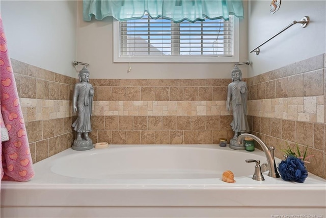 full bath featuring plenty of natural light and a garden tub