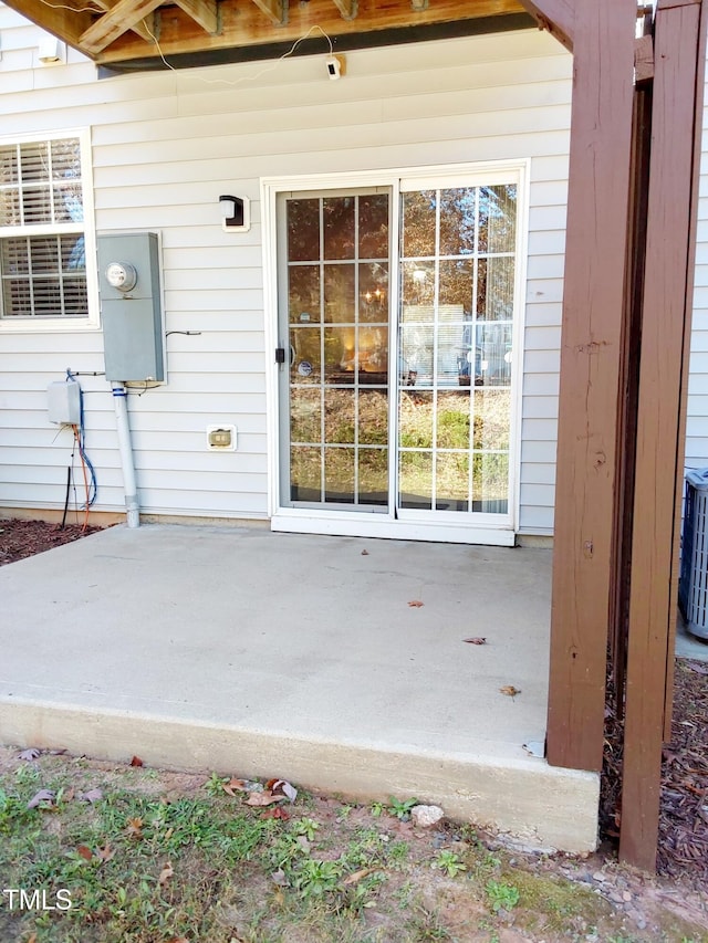 property entrance featuring a patio area and central AC unit