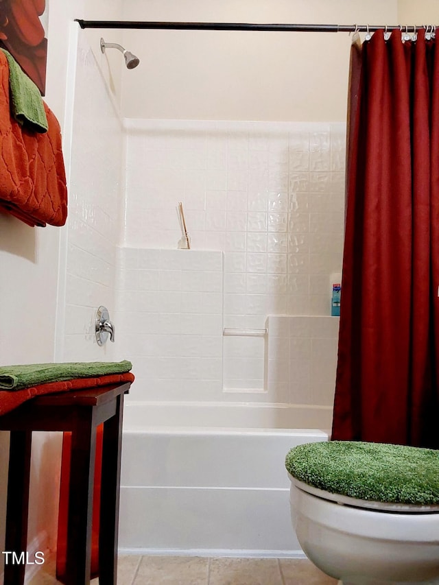 bathroom with toilet, shower / bath combination with curtain, and tile patterned flooring