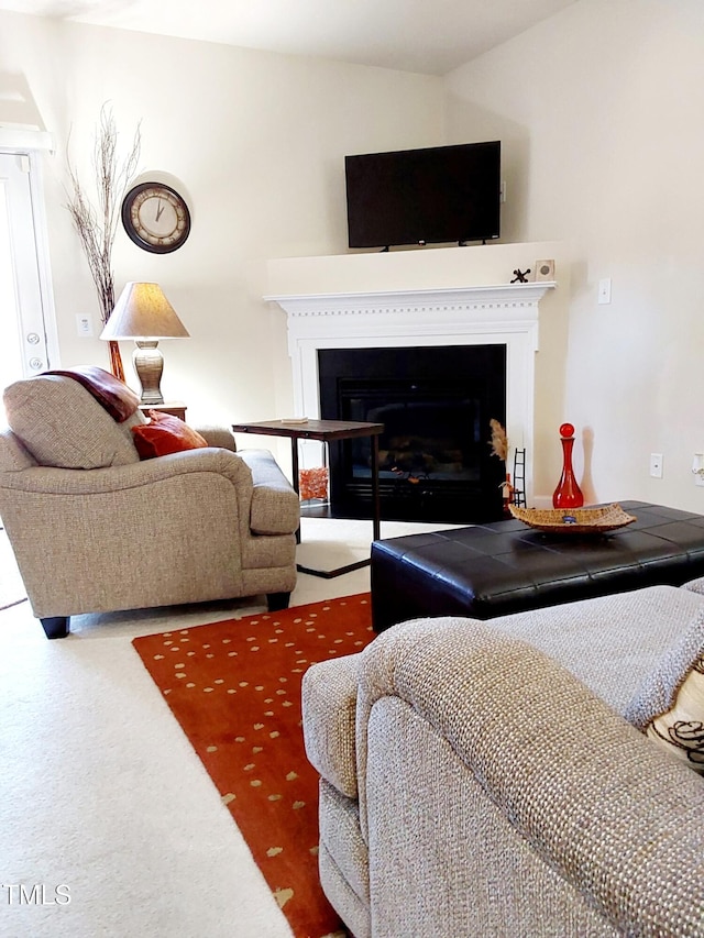 carpeted living area with a fireplace