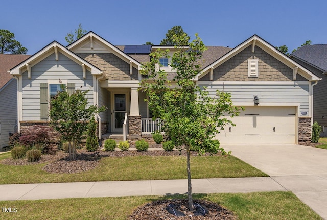 craftsman inspired home with stone siding, covered porch, a garage, and concrete driveway
