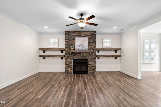 unfurnished living room with ornamental molding, a ceiling fan, baseboards, plenty of natural light, and dark wood finished floors