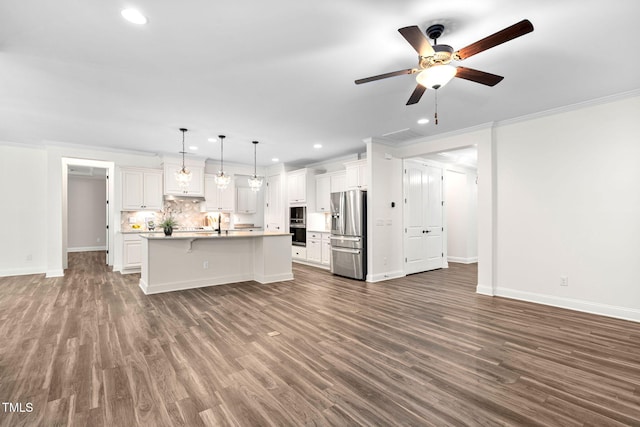 kitchen with stainless steel appliances, recessed lighting, ceiling fan, ornamental molding, and baseboards
