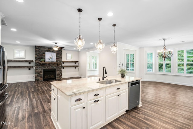 kitchen featuring a sink, stainless steel dishwasher, open floor plan, a chandelier, and a ceiling fan