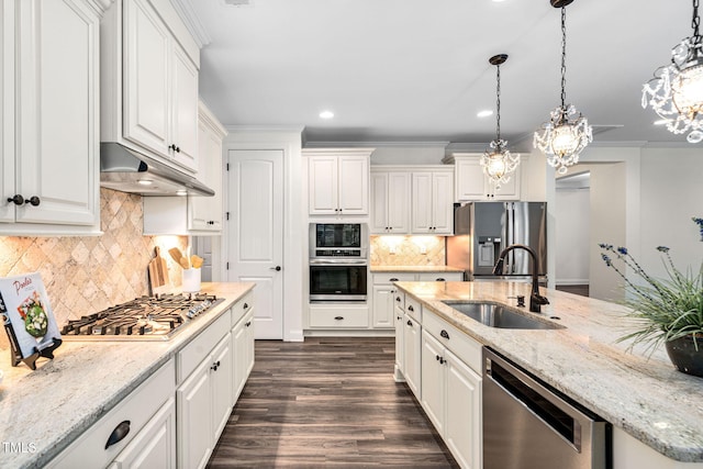 kitchen featuring stainless steel appliances, a sink, under cabinet range hood, a chandelier, and white cabinets