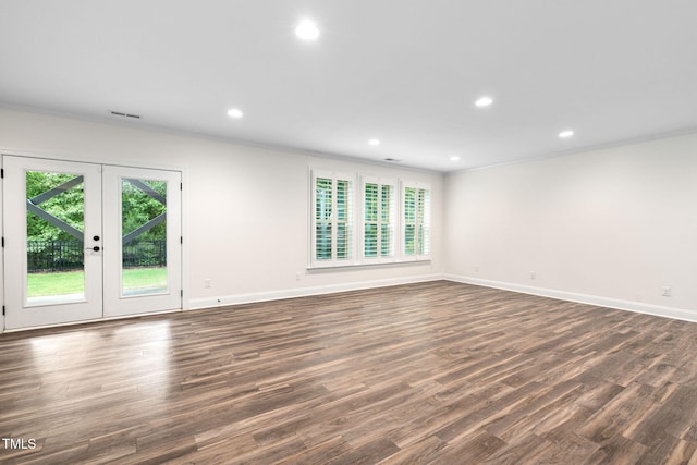 empty room featuring french doors, baseboards, dark wood-type flooring, recessed lighting, and ornamental molding