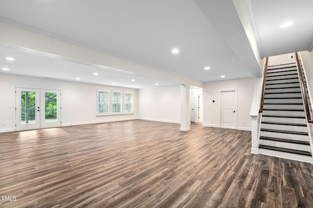 unfurnished living room with healthy amount of natural light, dark wood-type flooring, baseboards, recessed lighting, and crown molding