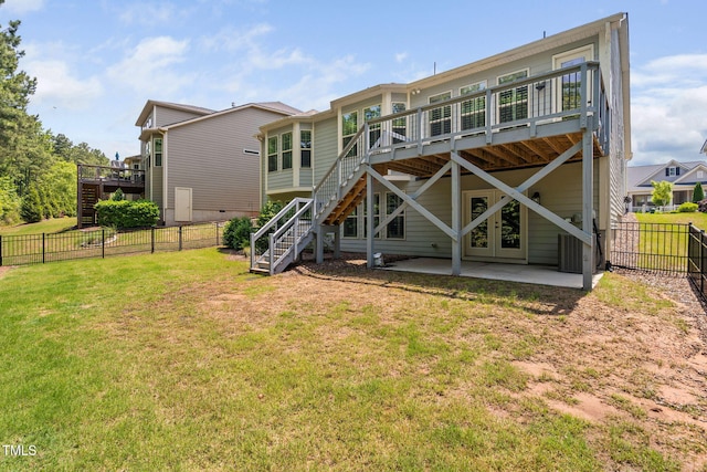 rear view of house with stairway, a deck, and a patio area