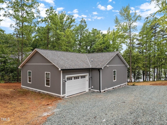 249 Fisherman Point Rd, Roxboro, NC 27574 - garage with driveway and view of scattered trees