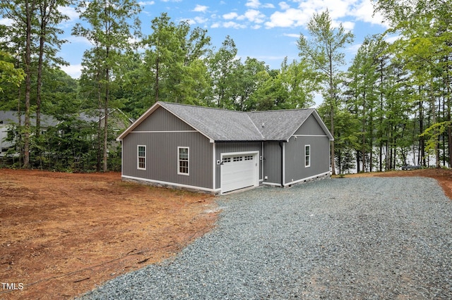 249 Fisherman Point Rd, Roxboro, NC 27574 - detached garage with gravel driveway and view of wooded area