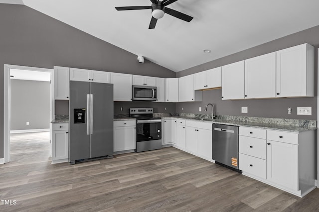 249 Fisherman Point Rd, Roxboro, NC 27574 - kitchen featuring stainless steel appliances, ceiling fan, light stone countertops, white cabinets, and high vaulted ceiling