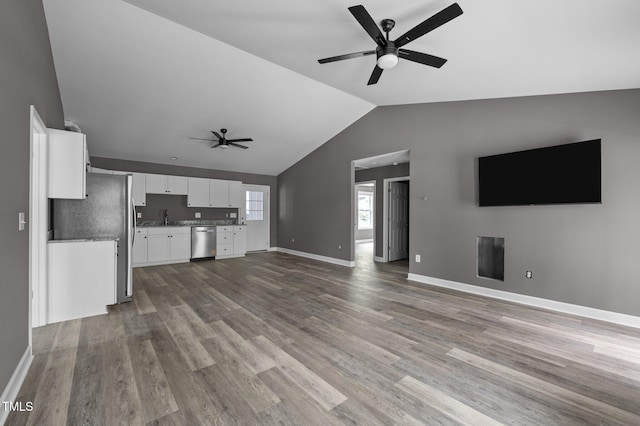 249 Fisherman Point Rd, Roxboro, NC 27574 - unfurnished living room with ceiling fan, a sink, lofted ceiling, wood finished floors, and baseboards