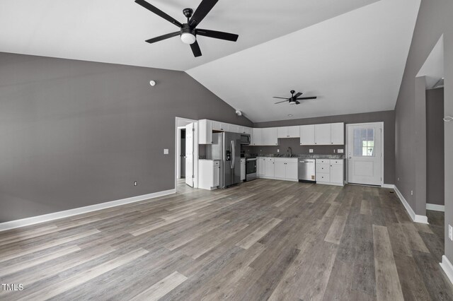 249 Fisherman Point Rd, Roxboro, NC 27574 - unfurnished living room with a ceiling fan, lofted ceiling, a sink, wood finished floors, and baseboards