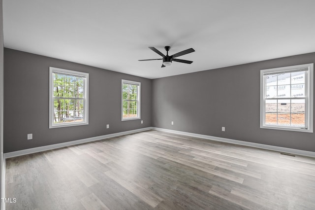 249 Fisherman Point Rd, Roxboro, NC 27574 - unfurnished room with wood finished floors, ceiling fan, and baseboards