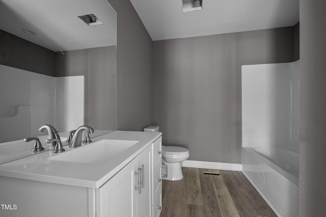 249 Fisherman Point Rd, Roxboro, NC 27574 - bathroom with vanity, toilet, wood finished floors, and washtub / shower combination