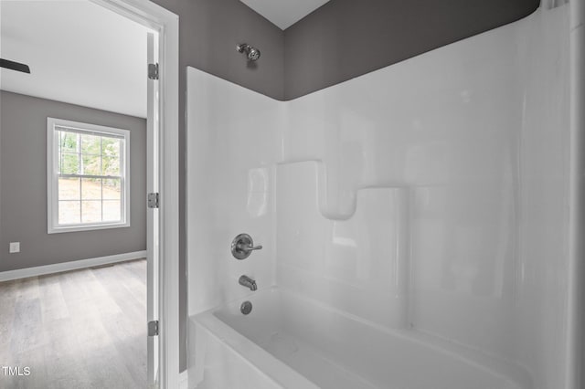 249 Fisherman Point Rd, Roxboro, NC 27574 - bathroom with shower / bathtub combination, baseboards, and wood finished floors