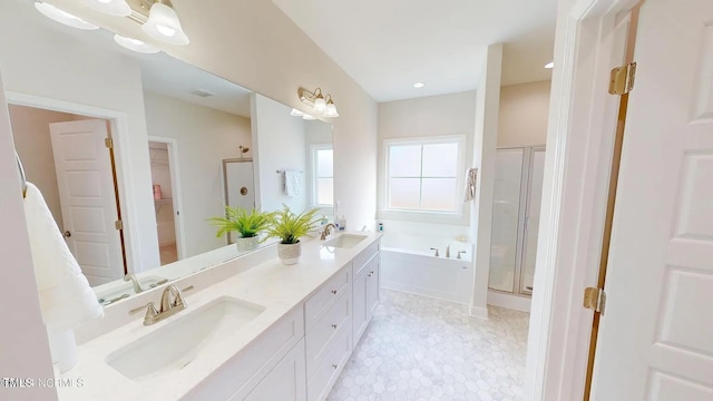 full bath with a garden tub, a shower stall, double vanity, a spacious closet, and recessed lighting