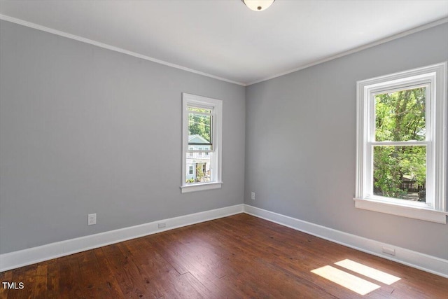 134 Nelson St, Durham, NC 27707 - spare room featuring baseboards, ornamental molding, and dark wood finished floors