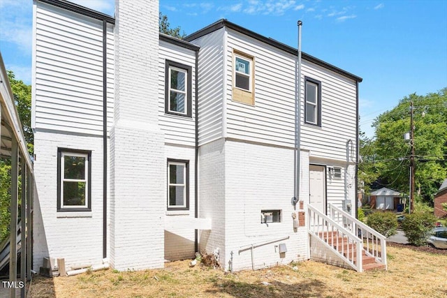 134 Nelson St, Durham, NC 27707 - rear view of property with entry steps, brick siding, and a chimney