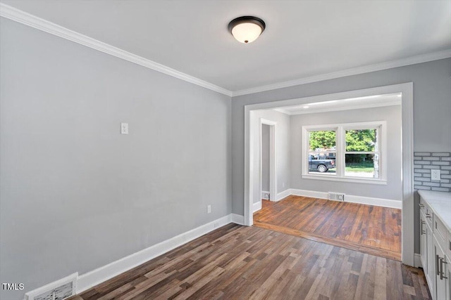 134 Nelson St, Durham, NC 27707 - unfurnished living room with dark wood-style flooring, baseboards, and ornamental molding