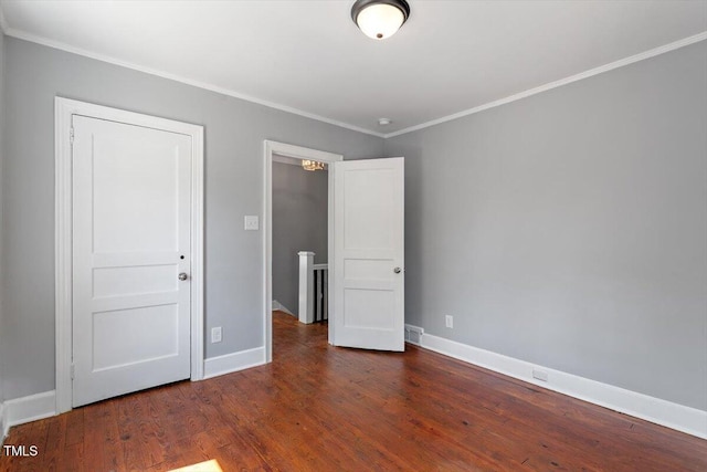 134 Nelson St, Durham, NC 27707 - unfurnished bedroom with crown molding, wood finished floors, and baseboards