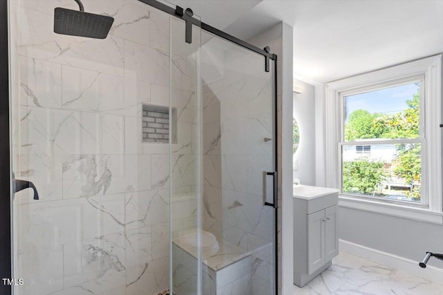 134 Nelson St, Durham, NC 27707 - bathroom with marble look tiles, a marble finish shower, vanity, and baseboards