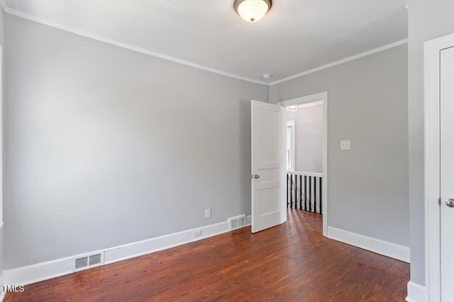134 Nelson St, Durham, NC 27707 - spare room with wood finished floors, crown molding, baseboards, and a smoke detector