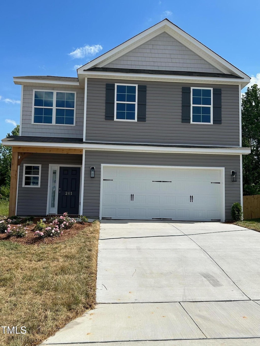 261 Plains Dr Unit 263, Burlington, NC 27217 - view of front of house with concrete driveway, a garage, and a front lawn