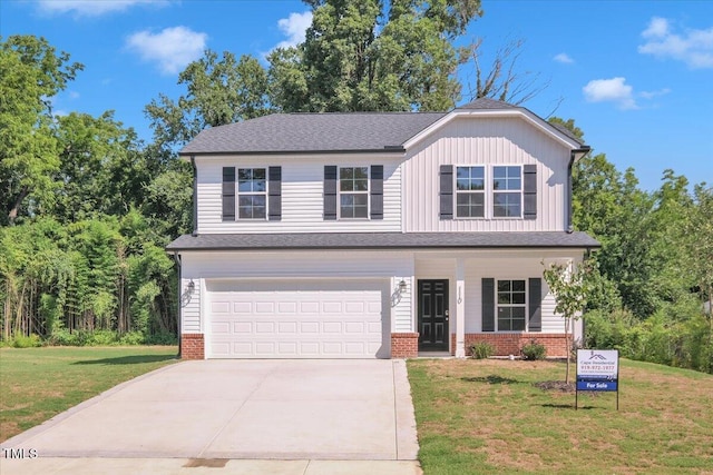 110 Hays St, Oxford, NC 27565 - view of front of property featuring driveway, a garage, a front lawn, and brick siding