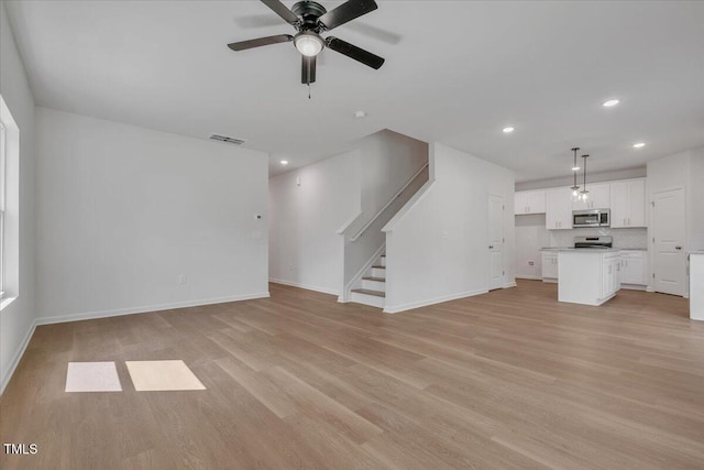 110 Hays St, Oxford, NC 27565 - unfurnished living room featuring ceiling fan, recessed lighting, light wood-type flooring, and stairway