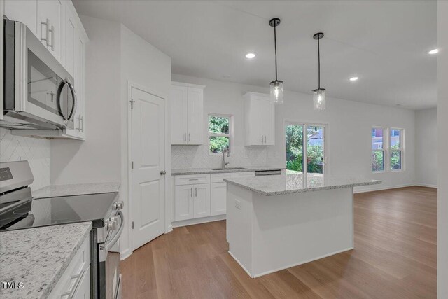 110 Hays St, Oxford, NC 27565 - kitchen featuring stainless steel appliances, light wood-style flooring, white cabinetry, backsplash, and recessed lighting