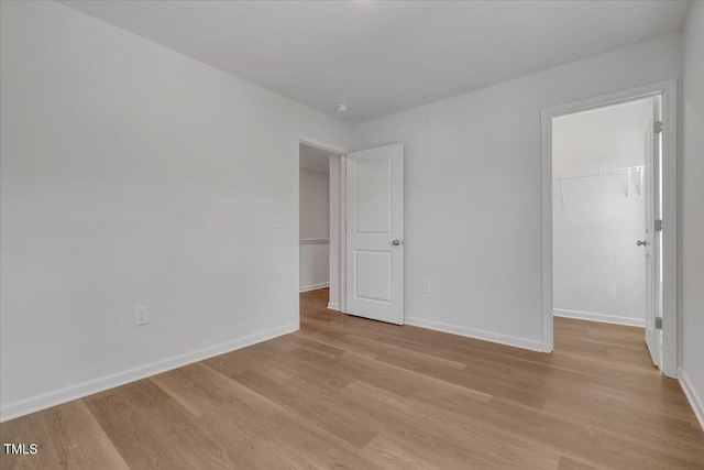 110 Hays St, Oxford, NC 27565 - unfurnished bedroom featuring a spacious closet, light wood finished floors, and a closet