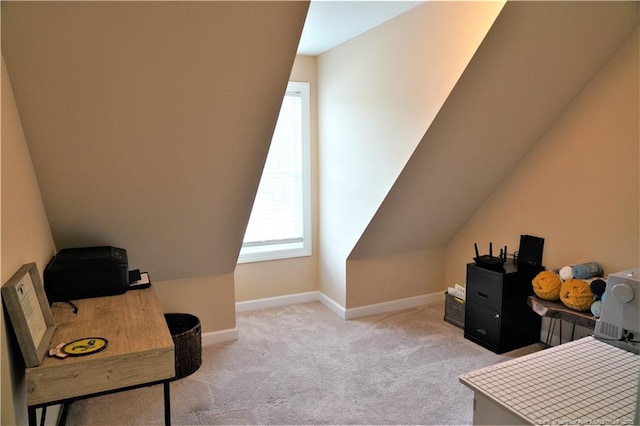 carpeted office space featuring baseboards and lofted ceiling
